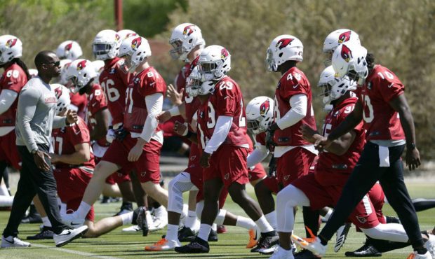Arizona Cardinals players stretch during an organized team activity at the NFL football team's trai...