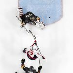 Washington Capitals left wing Jakub Vrana, center, scores on Vegas Golden Knights goaltender Marc-Andre Fleury, top, as defenseman Brayden McNabb trails during the second period in Game 5 of the NHL hockey Stanley Cup Finals Thursday, June 7, 2018, in Las Vegas. (AP Photo/John Locher)