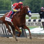 Justify (1), with jockey Mike Smith up, crosses the finish line to win the 150th running of the Belmont Stakes horse race and the Triple Crown, Sunday, June 10, 2018, in Elmont, N.Y. (AP Photo/Peter Morgan)