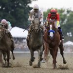 Justify (1), with jockey Mike Smith up, right, crosses the finish line ahead of Gronkowski, right, with jockey Jose Ortiz up, to win the 150th running of the Belmont Stakes horse race and the Triple Crown, Saturday, June 9, 2018, in Elmont, N.Y. (AP Photo/Julio Cortez)