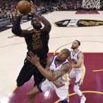 Cleveland Cavaliers' LeBron James shoots over Golden State Warriors' David West during the first half of Game 4 of basketball's NBA Finals, Friday, June 8, 2018, in Cleveland. (Gregory Shamus/Pool Photo via AP)