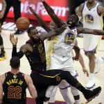 Cleveland Cavaliers' LeBron James is defended by Golden State Warriors' Draymond Green during the second half of Game 4 of basketball's NBA Finals, Friday, June 8, 2018, in Cleveland. (AP Photo/Tony Dejak)