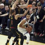 Golden State Warriors' Stephen Curry is defended by Cleveland Cavaliers' George Hill (3) and Kevin Love during the first half of Game 4 of basketball's NBA Finals, Friday, June 8, 2018, in Cleveland. (AP Photo/Carlos Osorio)