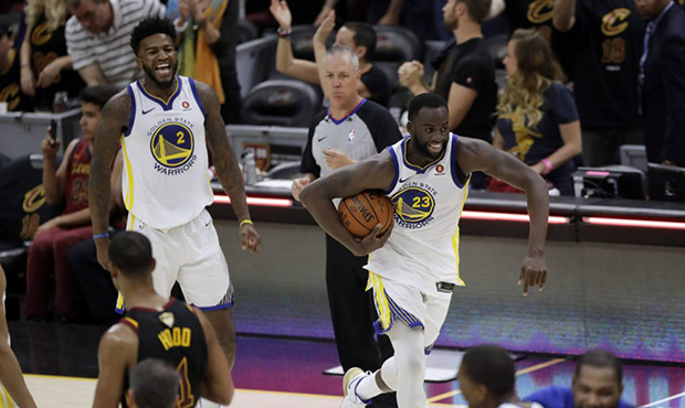 Golden State Warriors' Draymond Green (23) and Jordan Bell celebrate at the end of Game 4 of basket...