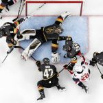 Vegas Golden Knights goaltender Marc-Andre Fleury, top center, flops as he tries to stop a shot during the second period in Game 5 of the NHL hockey Stanley Cup Finals against the Washington Capitals on Thursday, June 7, 2018, in Las Vegas. (AP Photo/John Locher)