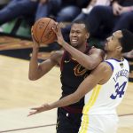 Cleveland Cavaliers guard Rodney Hood is defended by Golden State Warriors' Shaun Livingston in the first half of Game 4 of basketball's NBA Finals, Friday, June 8, 2018, in Cleveland. (AP Photo/Carlos Osorio)