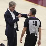 Golden State Warriors coach Steve Kerr talks with referee Scott Foster during the second half of Game 4 of basketball's NBA Finals against the Cleveland Cavaliers, Friday, June 8, 2018, in Cleveland. (AP Photo/Carlos Osorio)