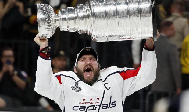 Washington Capitals left wing Alex Ovechkin, of Russia, hoists the Stanley Cup after the Capitals d...