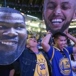 Fans react while watching television coverage of the Golden State Warriors playing the Cleveland Cavaliers in Game 4 of the NBA Finals, at Oracle Arena in Oakland, Calif., Friday, June 8, 2018. (AP Photo/Josh Edelson)