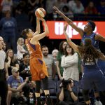 Phoenix Mercury's Diana Taurasi (3) hits a shot over Minnesota Lynx's Seimone Augustus (33) and Sylvia Fowles during the first half of a WNBA basketball game Friday, June 1, 2018, in Minneapolis. (David Joles/Star Tribune via AP)