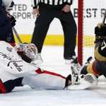 Washington Capitals goaltender Braden Holtby, left, gives up a goal to Vegas Golden Knights left wing David Perron, right, during the second period in Game 5 of the NHL hockey Stanley Cup Finals on Thursday, June 7, 2018, in Las Vegas. (AP Photo/John Locher)