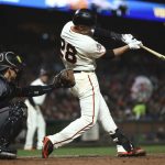San Francisco Giants' Buster Posey swings for a two RBI double off Arizona Diamondbacks' Fernando Salas in the fourth inning of a baseball game Monday, June 4, 2018, in San Francisco. (AP Photo/Ben Margot)