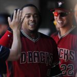 Arizona Diamondbacks' Ketel Marte, center, is congratulated as he returns to the dugout after hitting a solo home run off Colorado Rockies starting pitcher Kyle Freeland in the second inning of a baseball game Sunday, June 10, 2018, in Denver. (AP Photo/David Zalubowski)