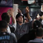 Arizona Diamondbacks' Paul Goldschmidt, center, is congratulated by teammates after hitting a two-run home run during the ninth inning of a baseball game against the Los Angeles Angels, Tuesday, June 19, 2018, in Anaheim, Calif. (AP Photo/Jae C. Hong)