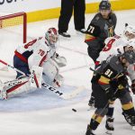 Washington Capitals goaltender Braden Holtby, left, is scored on by after a puck was deflected off of a skate during the second period in Game 5 of the NHL hockey Stanley Cup Finals against the Vegas Golden Knights on Thursday, June 7, 2018, in Las Vegas. Golden Knights defenseman Nate Schmidt, not seen, was credited with the goal. (AP Photo/Ross D. Franklin)