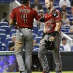 Arizona Diamondbacks' Ketel Marte (4) consoles Chris Owings (16) after Marte scored and Owings was thrown out at home on a single by Deven Marrero during the fifth inning of a baseball game against the Miami Marlins, Wednesday, June 27, 2018, in Miami. (AP Photo/Wilfredo Lee)