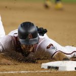 Arizona Diamondbacks' Jeff Mathis dives late back to first base as he is doubles up at first during the seventh inning of a baseball game against the Pittsburgh Pirates Wednesday, June 13, 2018, in Phoenix. The Pirates defeated the Diamondbacks 5-4. (AP Photo/Ross D. Franklin)