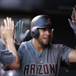 Arizona Diamondbacks' David Peralta is congratulated as he returns to the dugout after hitting a solo home run off Colorado Rockies starting pitcher German Marquez during the third inning of a baseball game Friday, June 8, 2018, in Denver. (AP Photo/David Zalubowski)