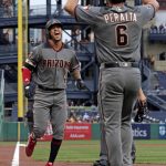 Arizona Diamondbacks' Ketel Marte (4) is greeted by David Peralta (6) as he crosses home plate after hitting two-run home run off Pittsburgh Pirates starting pitcher Chad Kuhl during the first inning of a baseball game in Pittsburgh, Thursday, June 21, 2018. (AP Photo/Gene J. Puskar)