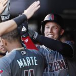 Arizona Diamondbacks' Jake Lamb, right, is congratulated after hitting a solo home run off Colorado Rockies starting pitcher German Marquez during the third inning of a baseball game Friday, June 8, 2018, in Denver. (AP Photo/David Zalubowski)