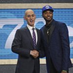 Villanova's Mikal Bridges, right, poses with NBA Commissioner Adam Silver after he was picked 10th overall by the Philadelphia 76ers during the NBA basketball draft in New York, Thursday, June 21, 2018. (AP Photo/Kevin Hagen)