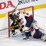 Vegas Golden Knights left wing David Perron, left, scores on Washington Capitals goaltender Braden Holtby, right, as he is pushed into the goal by defenseman Christian Djoos during the second period in Game 5 of the NHL hockey Stanley Cup Finals on Thursday, June 7, 2018, in Las Vegas. (AP Photo/Ross D. Franklin)