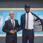 Texas' Mohamed Bamba, right, poses with NBA Commissioner Adam Silver after he was picked sixth overall by the Orlando Magic during the NBA basketball draft in New York, Thursday, June 21, 2018. (AP Photo/Kevin Hagen)