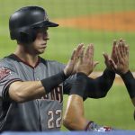 Arizona Diamondbacks' Jake Lamb (22) celebrates with teammates after scoring on a double by Nick Ahmed during the first inning of a baseball game against the Miami Marlins, Thursday, June 28, 2018, in Miami. (AP Photo/Wilfredo Lee)