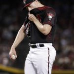 Arizona Diamondbacks starting pitcher Shelby Miller pulls his jersey up after giving up two runs to the San Francisco Giants during the third inning of a baseball game Saturday, June 30, 2018, in Phoenix. (AP Photo/Matt York)