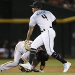 Arizona Diamondbacks shortstop Ketel Marte (4) tags out San Francisco Giants' Brandon Crawford, left, in a rundown between second and third base during the fourth inning of a baseball game Friday, June 29, 2018, in Phoenix. (AP Photo/Ross D. Franklin)