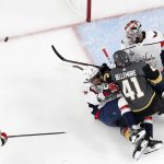 Washington Capitals defenseman Dmitry Orlov, second from left, collides with Vegas Golden Knights left wing Pierre-Edouard Bellemare (41), while goaltender Capitals goaltender Braden Holtby and defenseman Matt Niskanen look for the puck during the first period in Game 5 of the NHL hockey Stanley Cup Finals on Thursday, June 7, 2018, in Las Vegas. (AP Photo/John Locher)