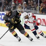 Vegas Golden Knights defenseman Colin Miller, left, moves the puck as Washington Capitals right wing Devante Smith-Pelly puts pressure on him during the first period in Game 5 of the NHL hockey Stanley Cup Finals on Thursday, June 7, 2018, in Las Vegas. (AP Photo/John Locher)