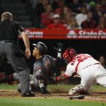 Arizona Diamondbacks' Ketel Marte, center, is tagged out by Los Angeles Angels catcher Martin Maldonado as he tries to score on a bunt hit by Jeff Mathis during the sixth inning of a baseball game, Monday, June 18, 2018, in Anaheim, Calif. (AP Photo/Jae C. Hong)