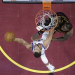 Golden State Warriors' Stephen Curry shoots against Cleveland Cavaliers' LeBron James during the second half of Game 4 of basketball's NBA Finals, Friday, June 8, 2018, in Cleveland. (AP Photo/Carlos Osorio, Pool)