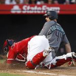 Arizona Diamondbacks' Paul Goldschmidt, rear, is tagged out by Los Angeles Angels catcher Martin Maldonado as he tried to score on a ball hit by David Peralta during the third inning of a baseball game Tuesday, June 19, 2018, in Anaheim, Calif. (AP Photo/Jae C. Hong)