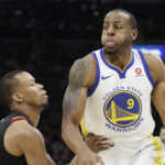 Golden State Warriors' Andre Iguodala is defended by Cleveland Cavaliers' Rodney Hood during the first half of Game 4 of basketball's NBA Finals, Friday, June 8, 2018, in Cleveland. (AP Photo/Tony Dejak)
