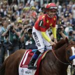 Jockey Mike Smith reacts after guiding Justify to win the 150th running of the Belmont Stakes horse race and the Triple Crown, Saturday, June 9, 2018, in Elmont, N.Y. (AP Photo/Julio Cortez)