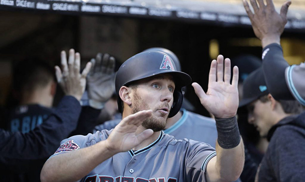 Arizona Diamondbacks' Jeff Mathis is congratulated in the dugout after scoring on a triple by Paul ...