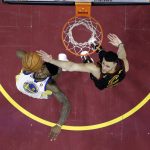 Golden State Warriors' Jordan Bell and Cleveland Cavaliers' Larry Nance Jr. reach for a rebound during the second half of Game 4 of basketball's NBA Finals, Friday, June 8, 2018, in Cleveland. (AP Photo/Carlos Osorio, Pool)