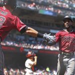 Arizona Diamondbacks Jarrod Dyson, right, is congratulated by Jake Lamb (22) after scoring against the San Francisco Giants in the sixth inning of a baseball game Wednesday, June 6, 2018, in San Francisco. (AP Photo/Ben Margot)