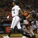 Arizona Diamondbacks' Ketel Marte scores as San Francisco Giants catcher Buster Posey, right, kneels at home plate during the sixth inning of a baseball game Friday, June 29, 2018, in Phoenix. (AP Photo/Ross D. Franklin)