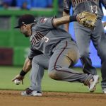 Arizona Diamondbacks second baseman Daniel Descalso (3) bobbles a ball hit by Miami Marlins' Derek Dietrich during the third inning of a baseball game, Thursday, June 28, 2018, in Miami. Descalso was charged with an error as Dietrich reached first base. (AP Photo/Wilfredo Lee)