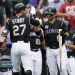 Colorado Rockies' Trevor Story, left, is congratulated by Gerardo Parra as Story heads to the dugout after his two-run home run off Arizona Diamondbacks starting pitcher Matt Koch during the third inning of a baseball game Saturday, June 9, 2018, in Denver. (AP Photo/David Zalubowski)