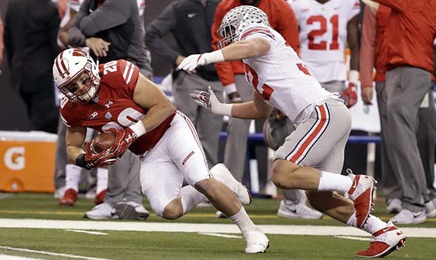 Wisconsin fullback Austin Ramesh, left, is tackled by Ohio State linebacker Tuf Borland during the ...