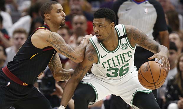 Boston Celtics' Marcus Smart (36) drives past Cleveland Cavaliers' George Hill (3) during the first...