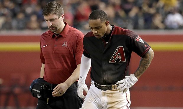 Arizona Diamondbacks shortstop Ketel Marte limps to the dugout after being thrown out at first duri...