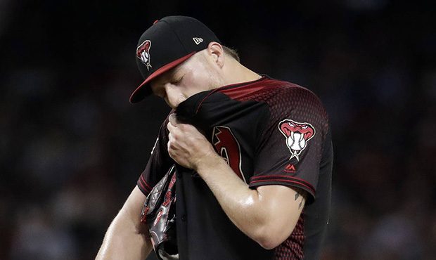 Arizona Diamondbacks starting pitcher Shelby Miller pulls his jersey up after giving up two runs to...