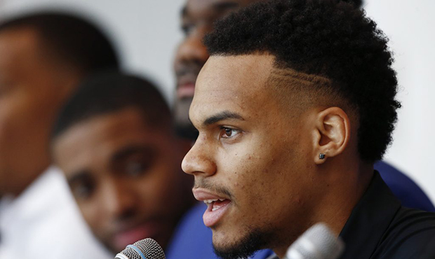 Phoenix Suns' Elie Okobo, of France, answers a question as the team introduces its new players afte...