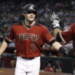Arizona Diamondbacks' A.J. Pollock (11) is congratulated by teammate Daniel Descalso after scoring a run against the Colorado Rockies on a Steven Souza double during the first inning of a baseball game, Sunday, July 22, 2018, in Phoenix. (AP Photo/Ralph Freso)
