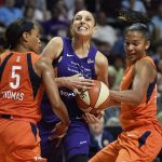 Connecticut Sun guard Jasmine Thomas (5) picks up the foul as she and teammate Alyssa Thomas, right, defend against Phoenix Mercury guard Diana Taurasi during the second half of a WNBA basketball game Friday, July 13, 2018, in Uncasville, Conn. (Sean D. Elliot/The Day via AP)